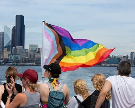 Fans wave a rainbow flag in a water taxi in Seattle