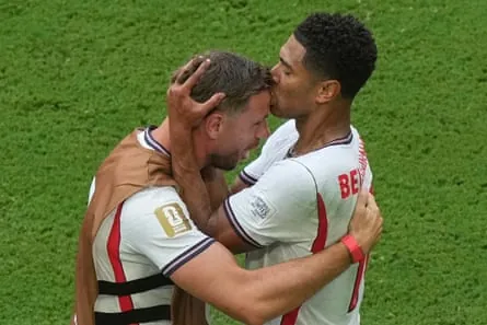 England’s Jude Bellingham kisses Jordan Henderson on the head