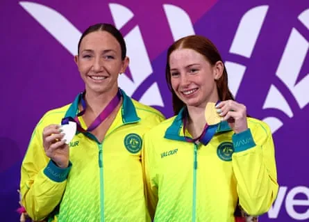 Mollie O'Callaghan on the podium with Lani Pallister after their gold and silver in the 200m freestyle