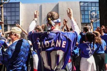 France supporters outside the French football federation’s headquarters, in France shirts, one with “Zidane 10” on the back