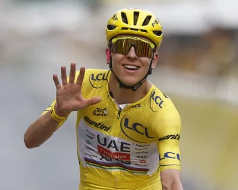 Tadej Pogacar wearing the yellow jersey on the finish line of stage 21.